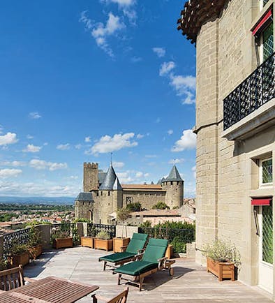 Hotel de la Cite Carcassonne Languedoc Roussillon terrace sun loungers overlooked by a chateau