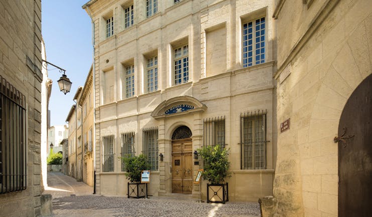 Maison d'Uzes Languedoc Roussillon exterior building wooden door and topiary bushes