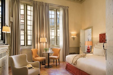 Maison d'Uzes Languedoc Roussillon junior suite bedroom with red head board white fireplace