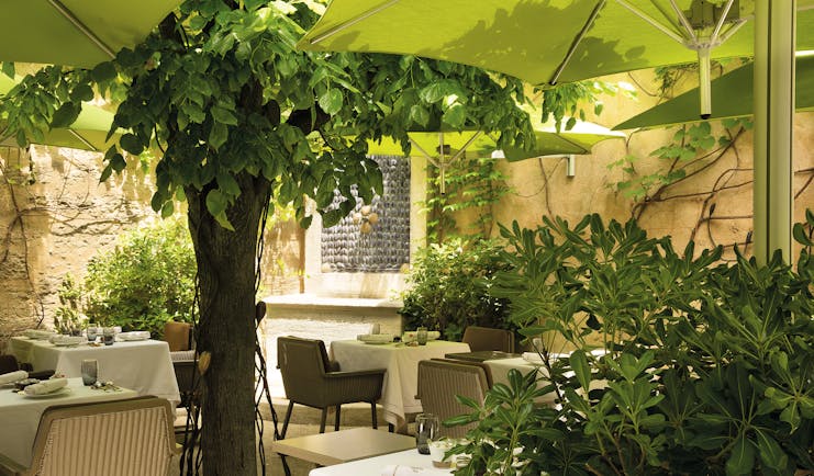 Maison d'Uzes Languedoc Roussillon patio terrace dining courtyard patio with trees and umbrellas