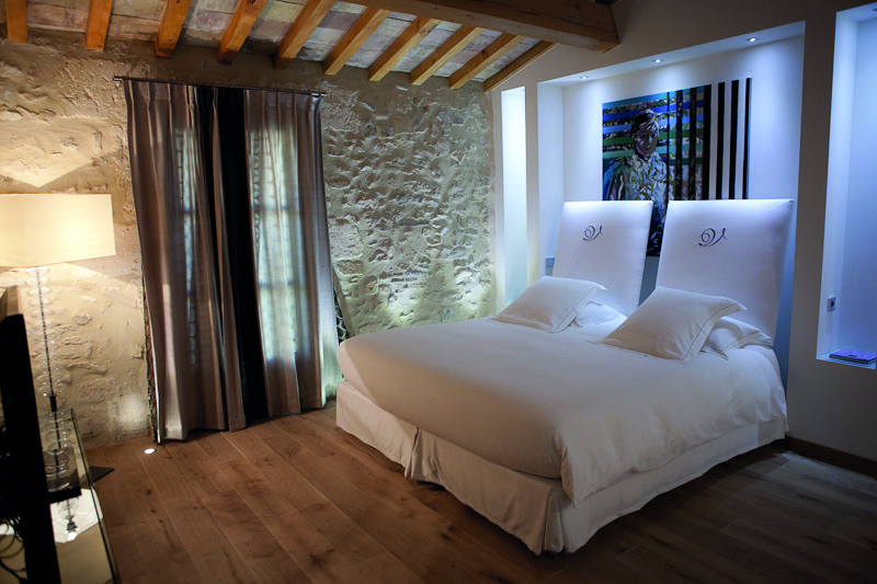 Le Domaine de Verchant Languedoc Roussillon junior suite bedroom with painting behind the bed