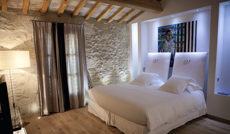 Le Domaine de Verchant Languedoc Roussillon junior suite bedroom with painting behind the bed