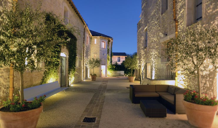 Le Domaine de Verchant Languedoc Roussillon outdoor two large stone buildings night time with ornamental trees
