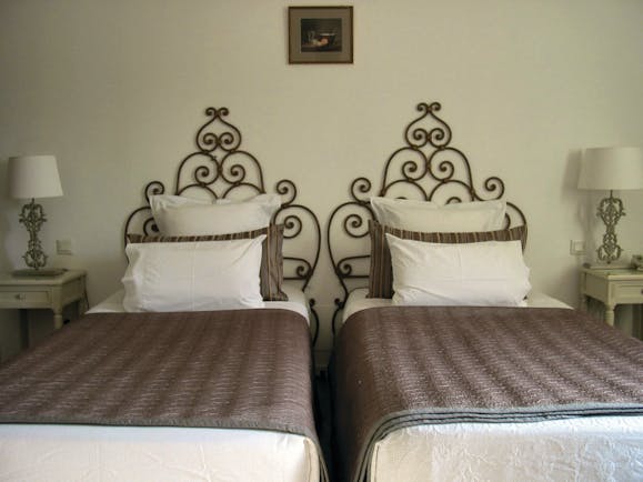 Relais des Chartreuses Languedoc Roussillon room with two beds and wrought iron head boards