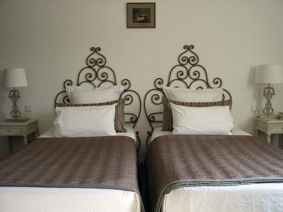 Relais des Chartreuses Languedoc Roussillon room with two beds and wrought iron head boards