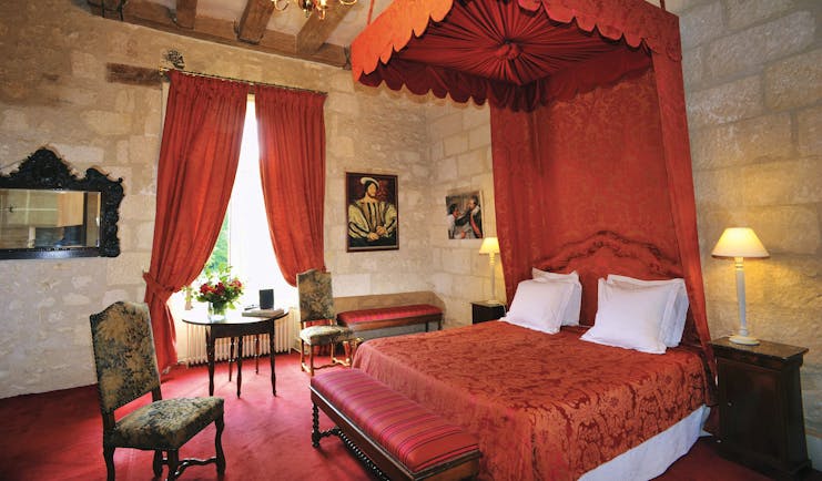 Chateau de la Bourdaisiere Loire Valley bedroom stone walls red canopy drapes traditional decor