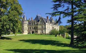 Chateau de la Bourdaisiere Loire Valley exterior large chateau with turrets and a grey roof overlooking lawn