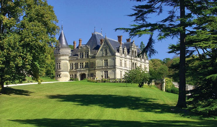 Chateau de la Bourdaisiere Loire Valley exterior large chateau with turrets and a grey roof overlooking lawn