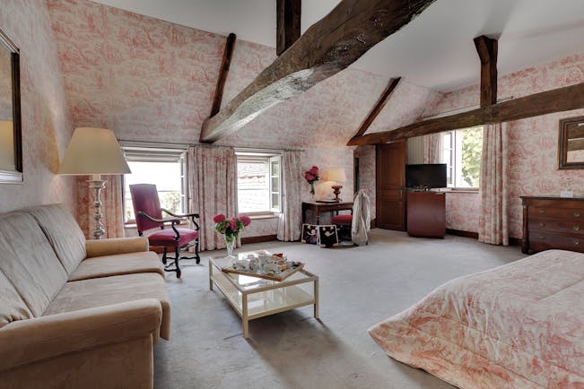 Chateau de Marcay Loire Valley large bedroom exposed wooden beams sofa and coffee table