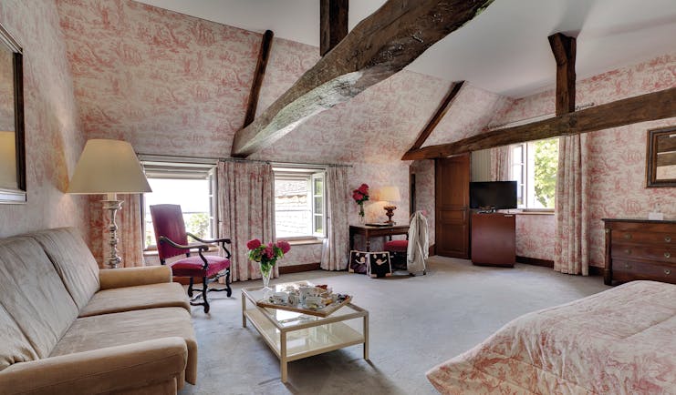 Chateau de Marcay Loire Valley large bedroom exposed wooden beams sofa and coffee table