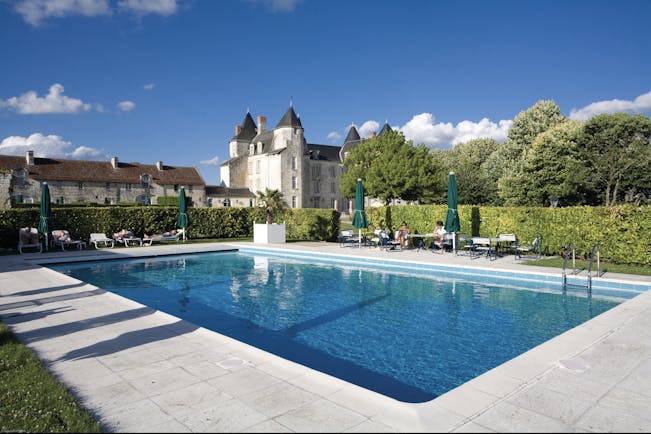 Chateau de Marcay Loire Valley outdoor swimming pool with sun loungers and umbrellas 