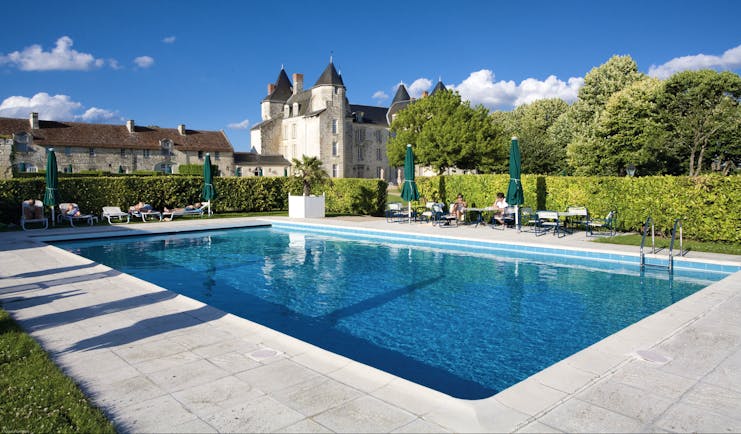 Chateau de Marcay Loire Valley outdoor swimming pool with sun loungers and umbrellas