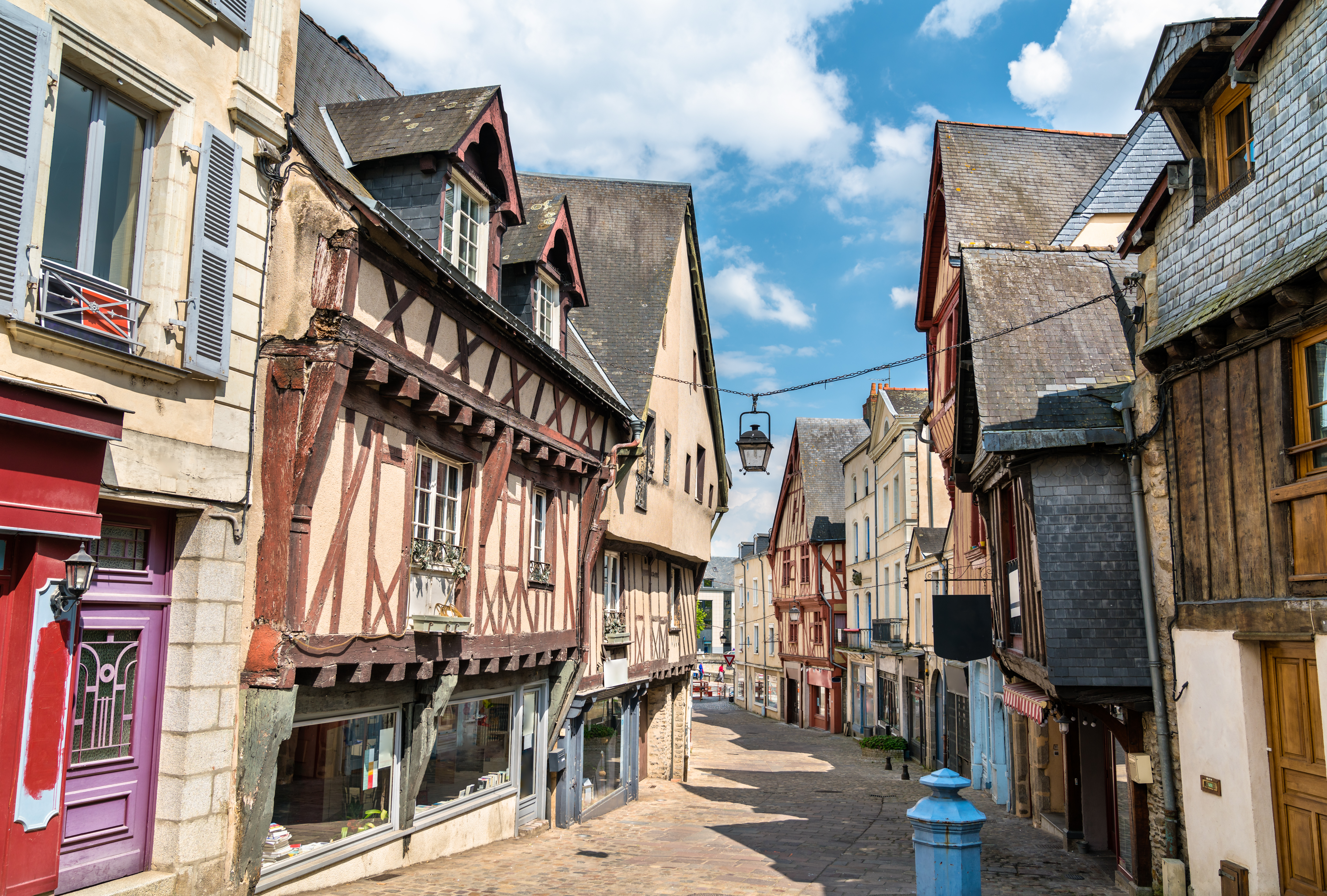 Gabled and half-timbered painted houses in street in Laval