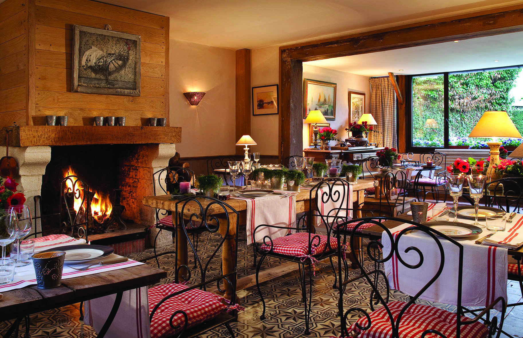 Auberge de la Source Normandy restaurant dining area with wooden tables and large fireplace