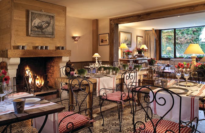 Auberge de la Source Normandy restaurant dining area with wooden tables and large fireplace