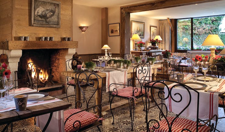 Auberge de la Source Normandy restaurant dining area with wooden tables and large fireplace