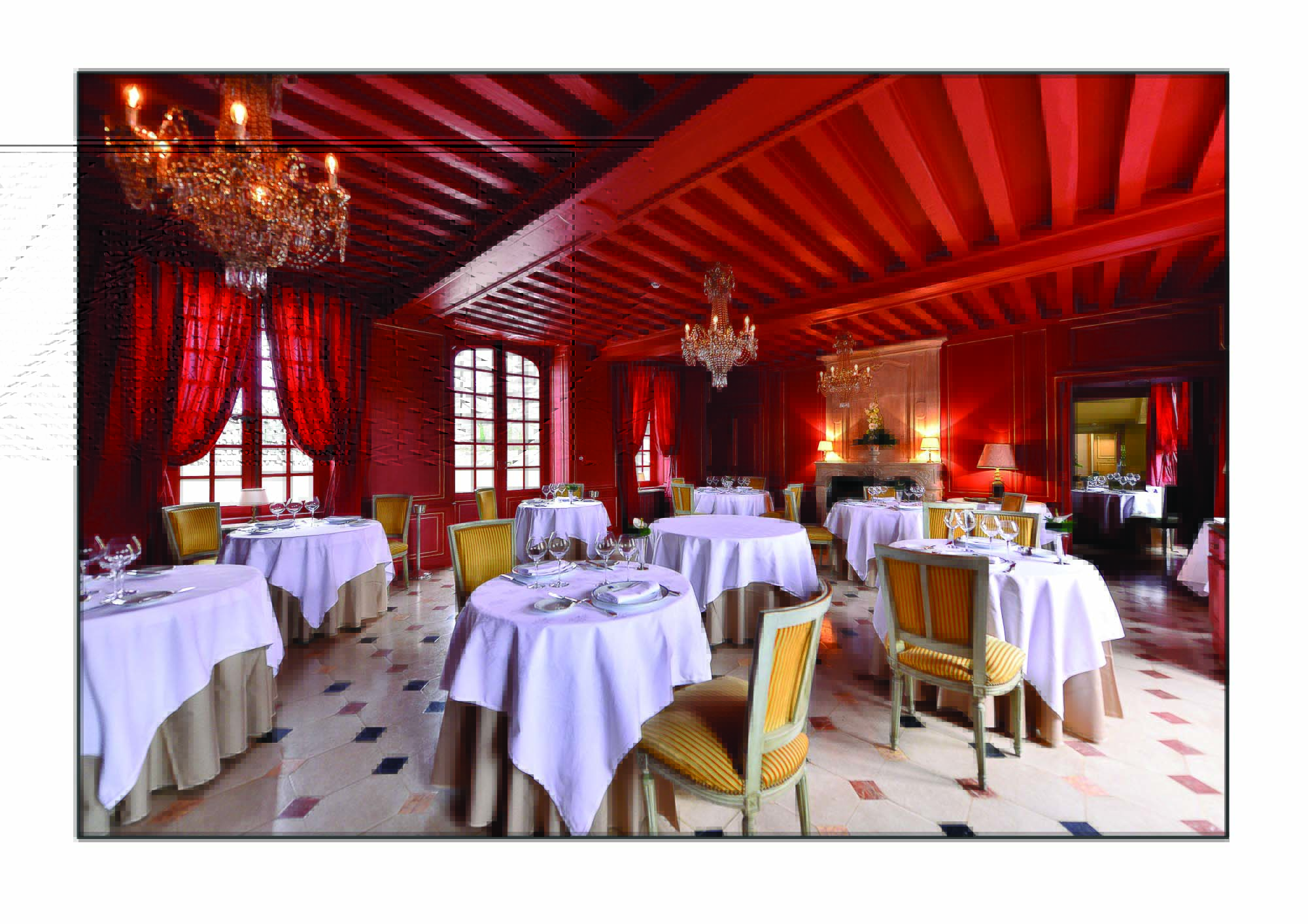 Chateau d'Audrieu dining area with red ceilings and walls and dining tables set up around the room 