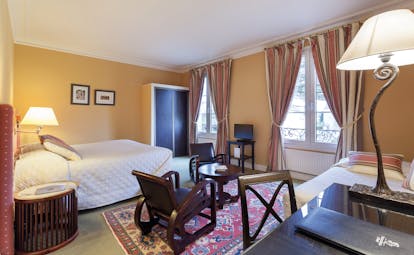 Chateau de Sully classic room, double bed, desk, chair, lamp, cosy traditional decor