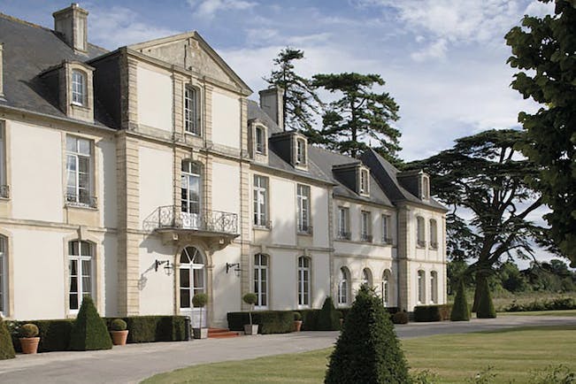 Chateau de Sully exterior, hotel building, balcony windows, lawns, trees