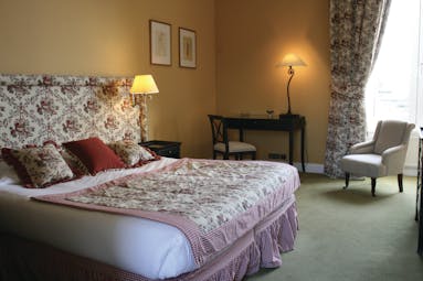 Chateau de Sully guestroom, double bed, armchair, grand traditional decor
