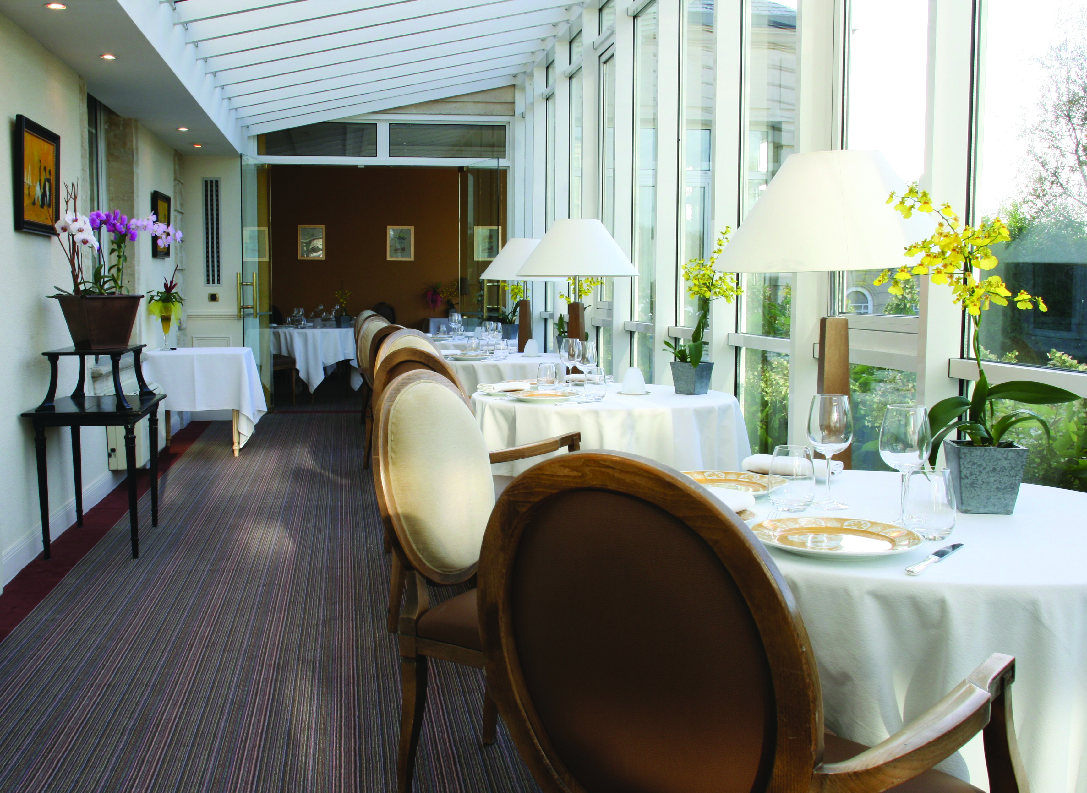 Chateau de Sully restaurant, tables and chairs, fresh modern decor, tables placed in front of window