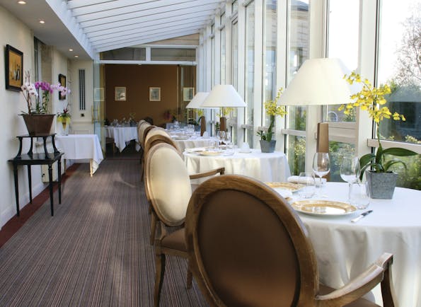 Chateau de Sully restaurant, tables and chairs, fresh modern decor, tables placed in front of window
