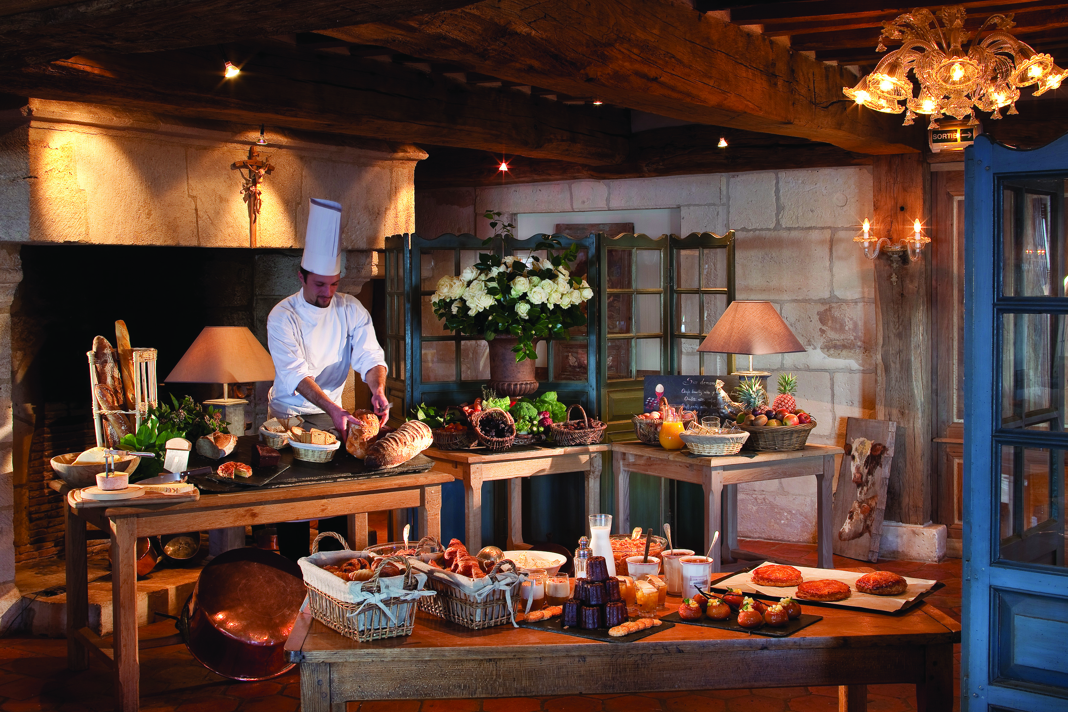 La Ferme Saint Simeon Normandy buffet breakfast bench two large tables with bread and pastries