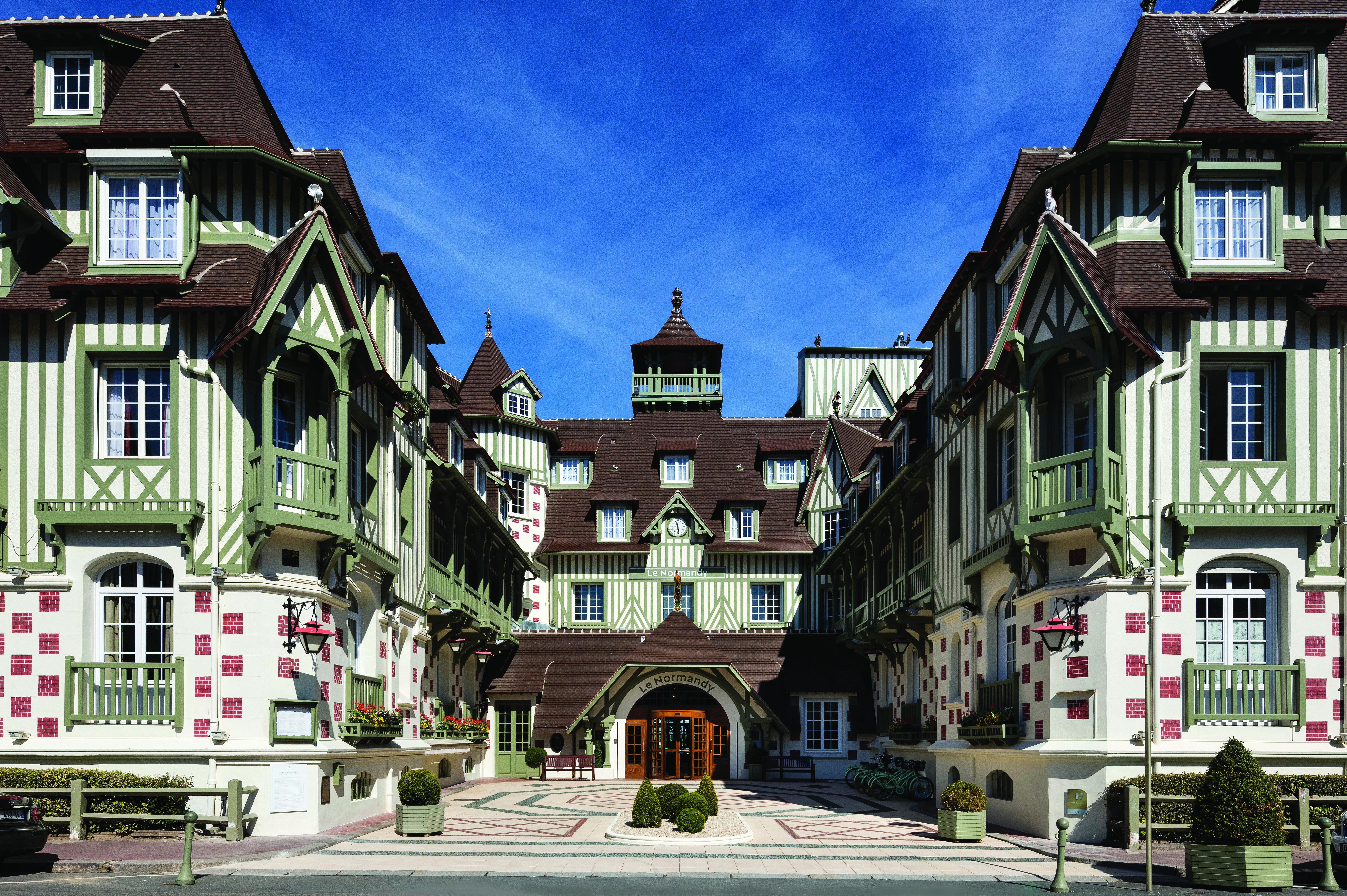 Exterior view of the hotel a big building with green stripes 