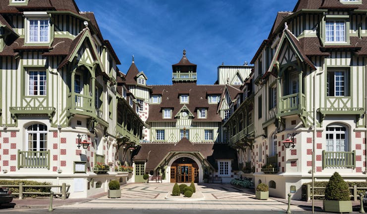 Exterior view of the hotel a big building with green stripes