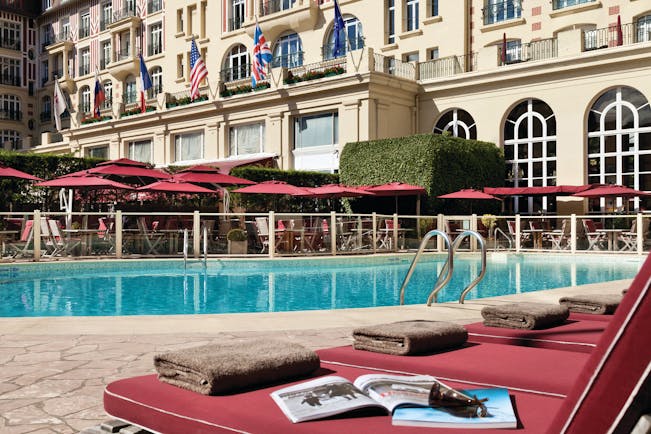 Hotel Royal Barriere pool, sun loungers, umbrellas, hotel building in background