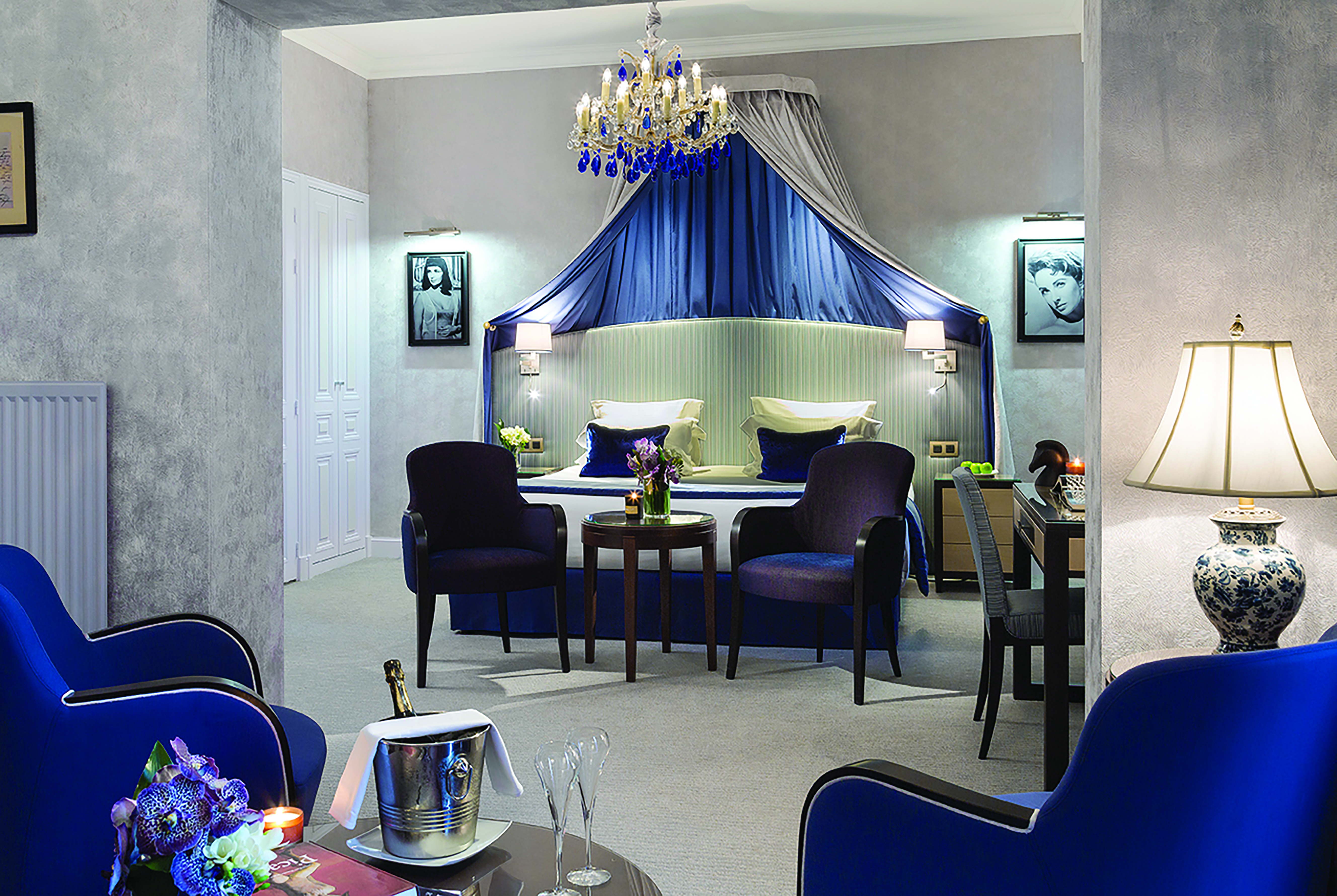Hotel Royal Barriere prestige suite, elegant decor, blue velvet armchairs, seperate seating area, canopied bed