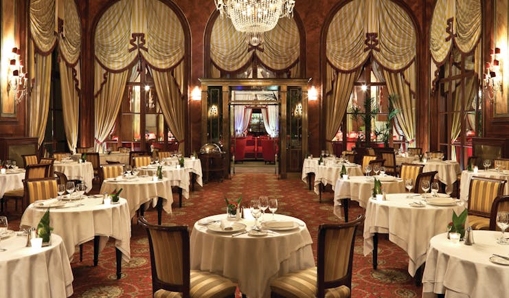 Hotel Royal Barriere restaurant, traditional decor, tables chairs, drapery, chandelier