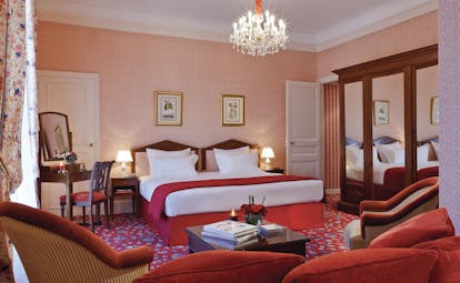 Hotel Royal Barriere terrace room, double bed, armchairs, colourful traditional decor