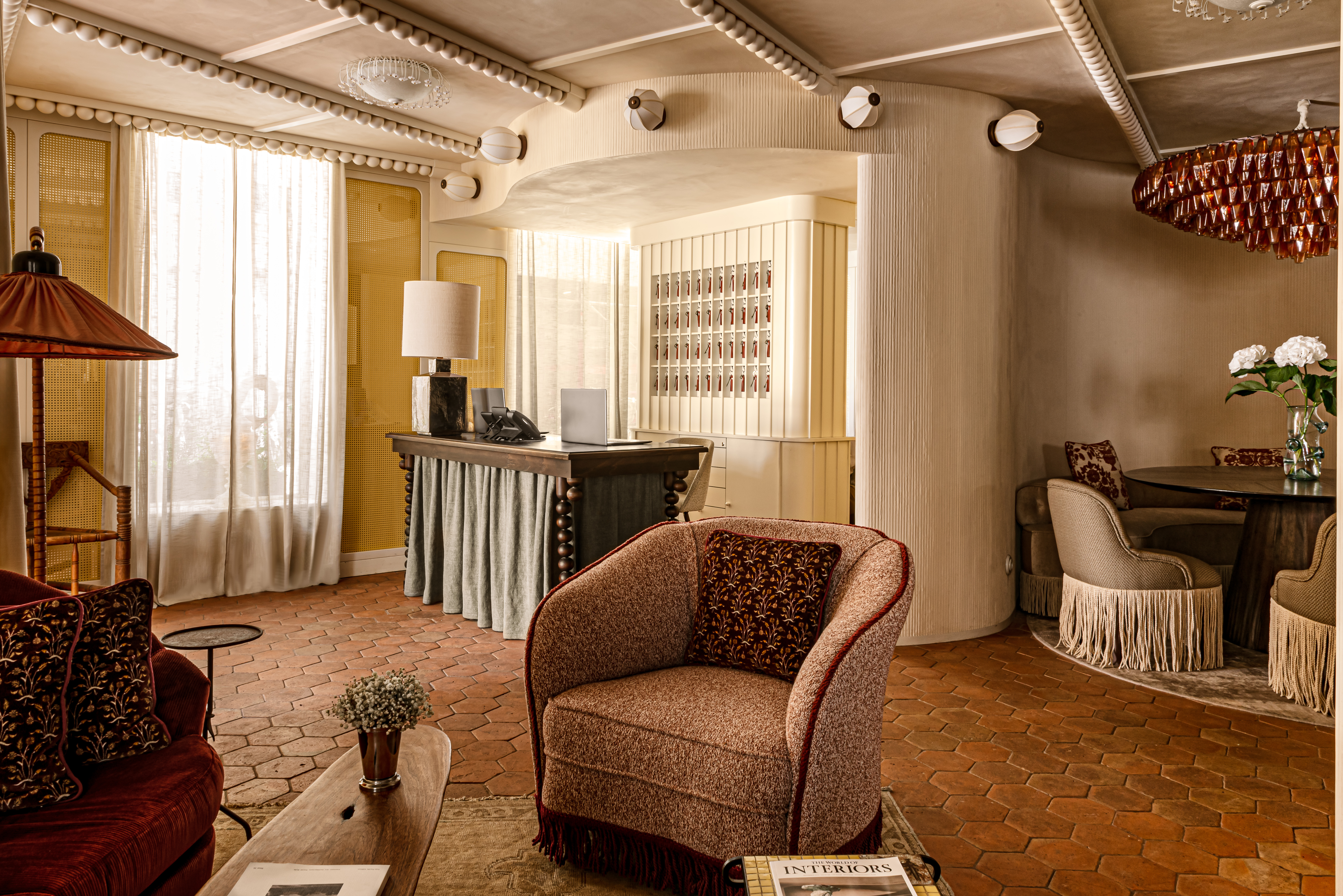 Chateau des Fleurs lounge area with floral patterns, terracotta tiled floor, and decorative ceiling