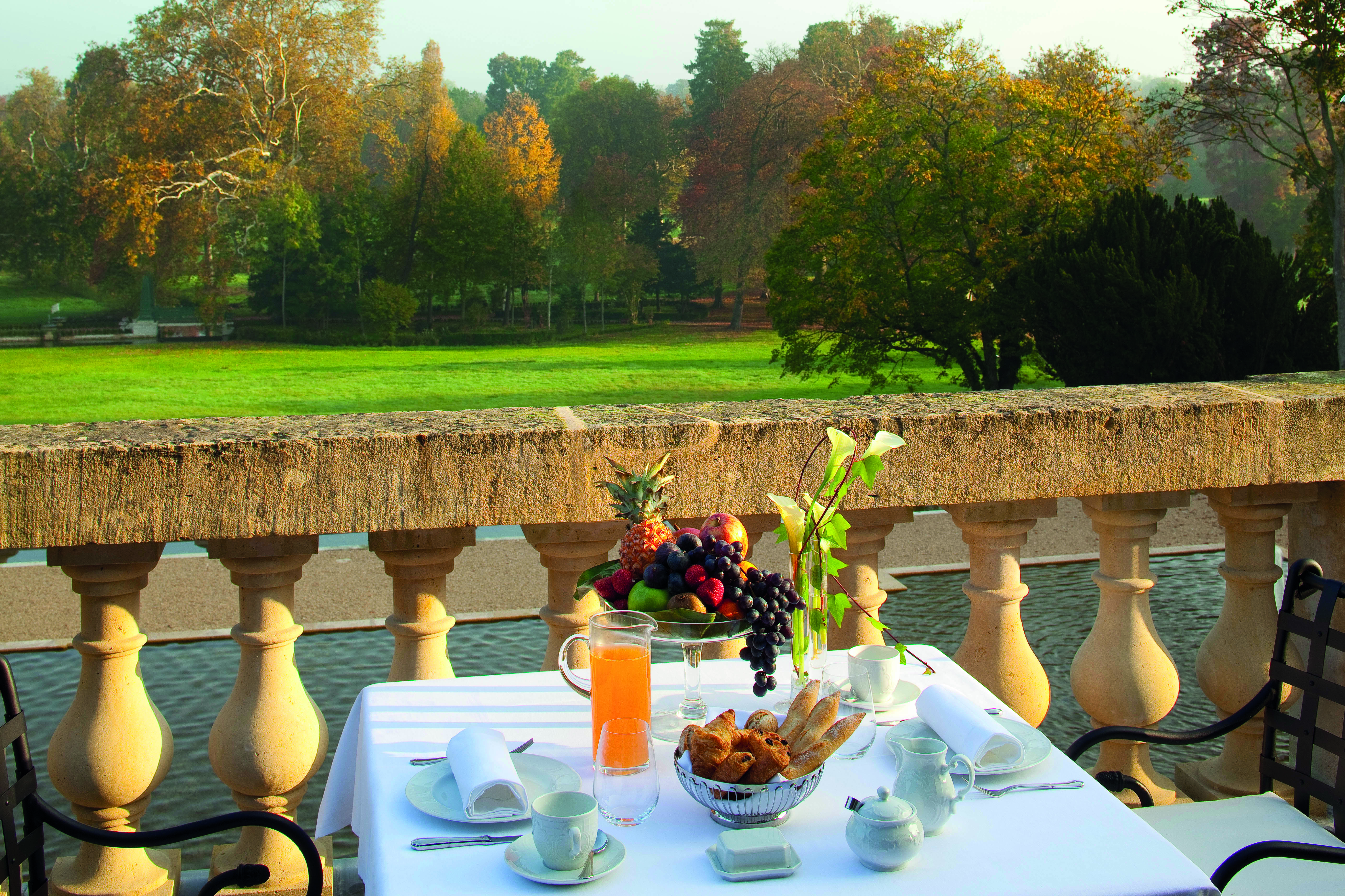 Auberge du Jeu de Paume Paris balcony terrace table fruit and pastries lawn view