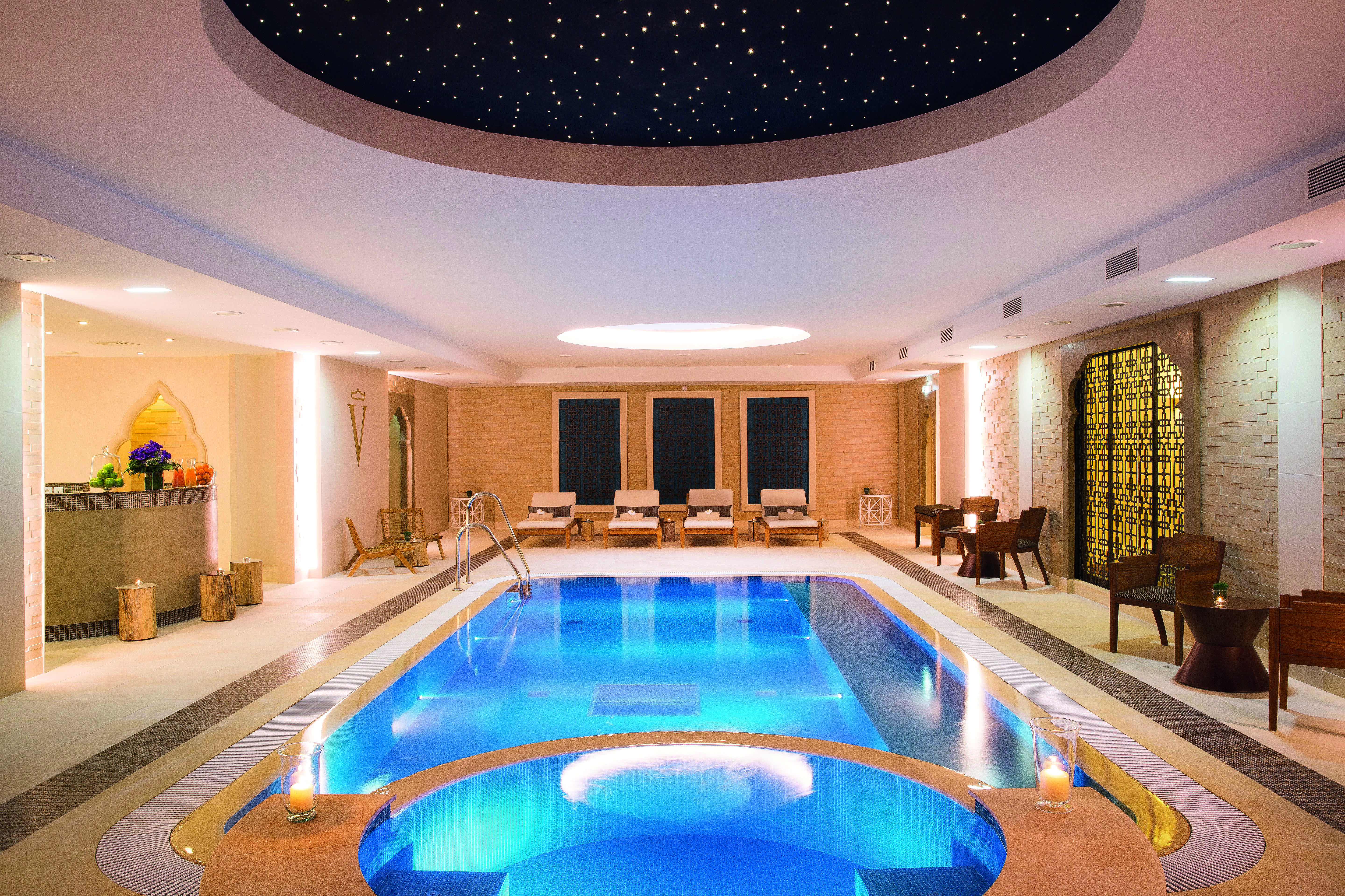 Auberge du Jeu de Paume Paris indoor pool with loungers and a dark blue domed ceiling