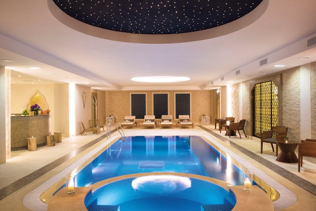 Auberge du Jeu de Paume Paris indoor pool with loungers and a dark blue domed ceiling