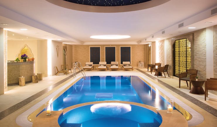 Auberge du Jeu de Paume Paris indoor pool with loungers and a dark blue domed ceiling