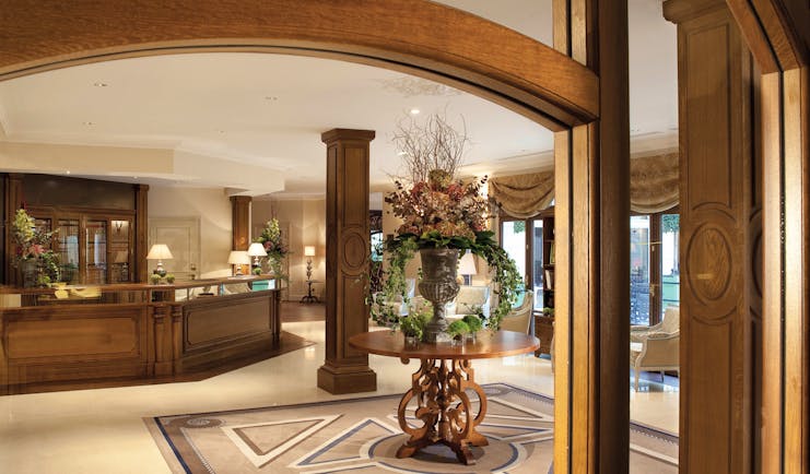 Auberge du Jeu de Paume Paris lobby with wooden beams table with large floral arrangement chandelier