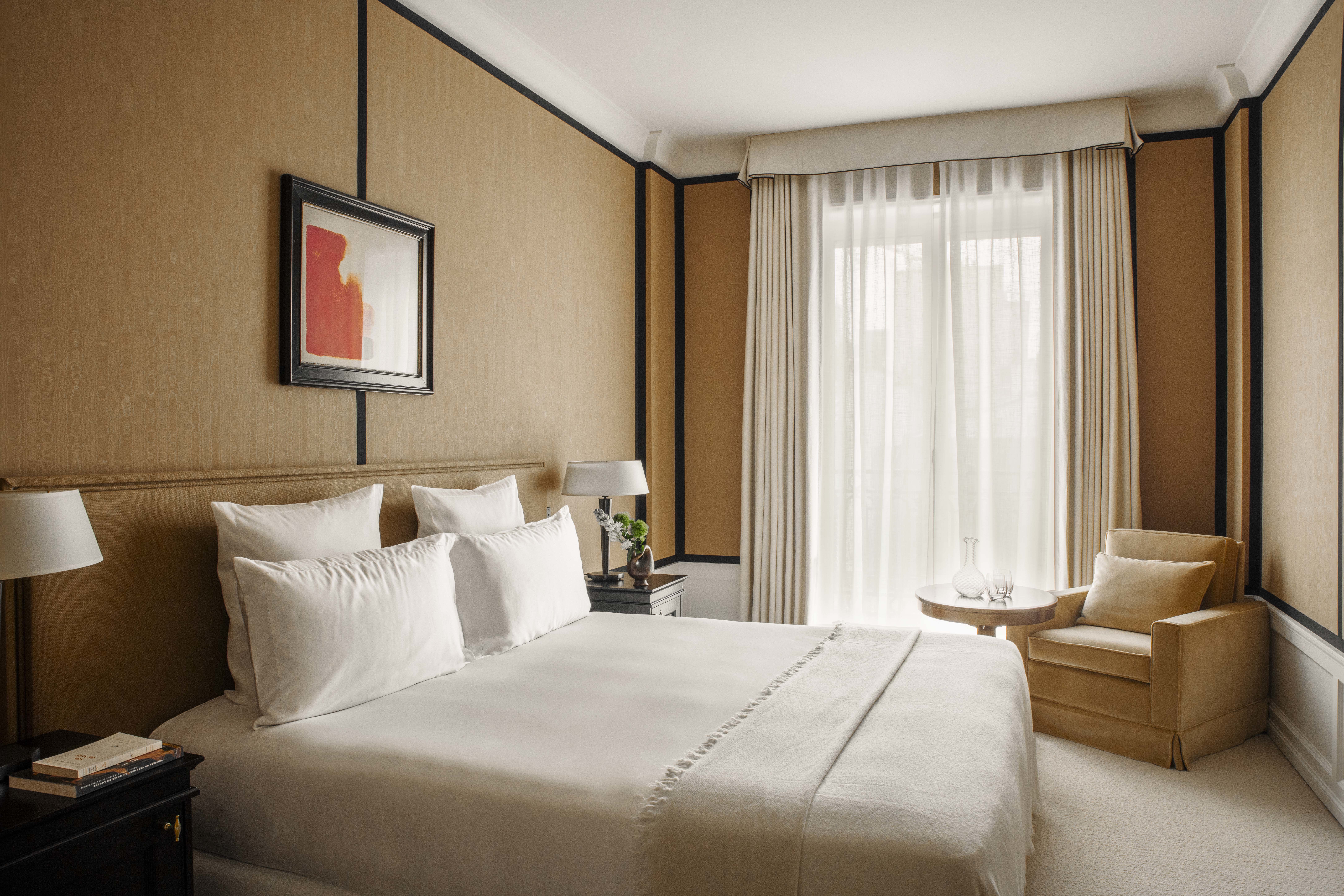 Hotel Balzac Superior Room with neutral palette, warm ochre walls, and white bed linen