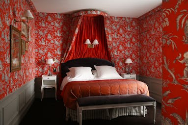 Hotel de Buci bourbon conde suite, double bed with canopy, red and colourful decor