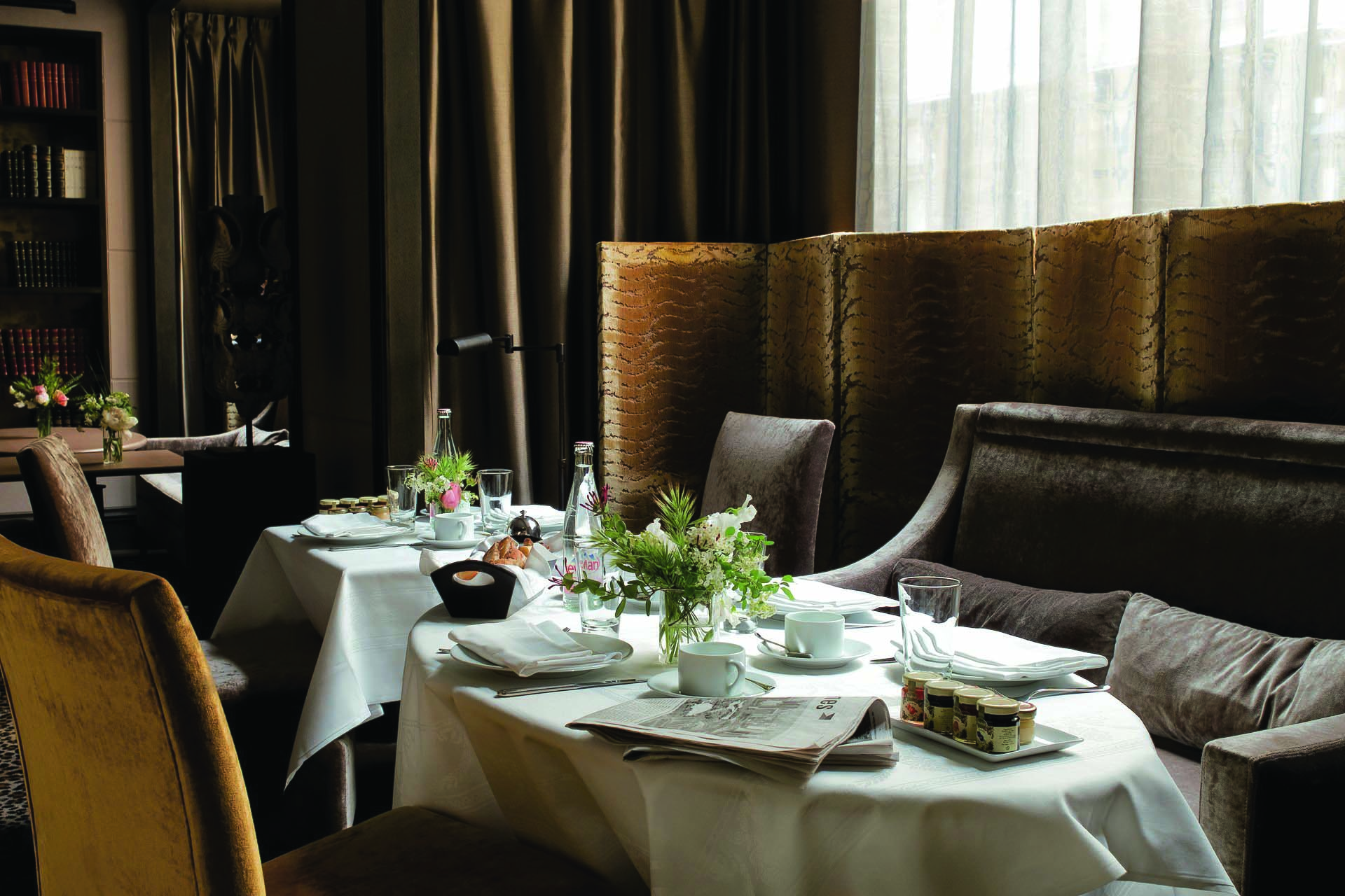 Hotel Esprit Saint Germain Paris breakfast lounge table laid with cutlery and flowers