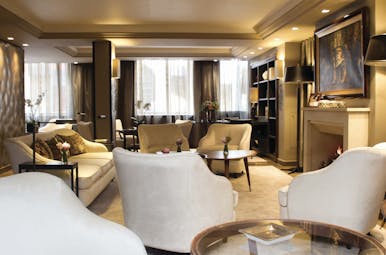 Hotel Esprit Saint Germain Paris fireplace lounge cream armchairs sofa and large painting above a fireplace