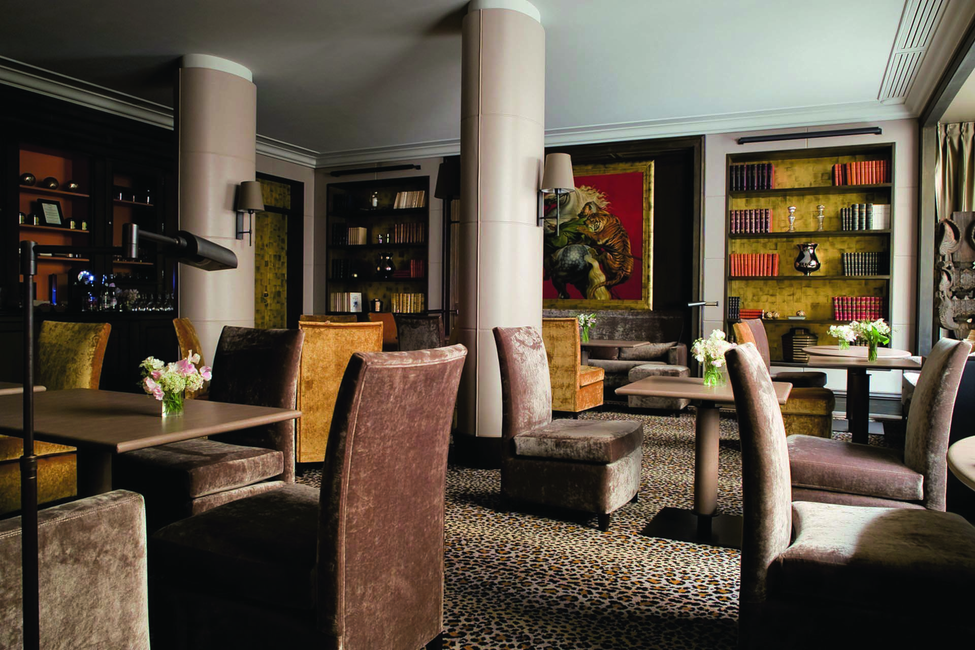 Hotel Esprit Saint Germain Paris library lounge with animal print carpet and large painting of a tiger 