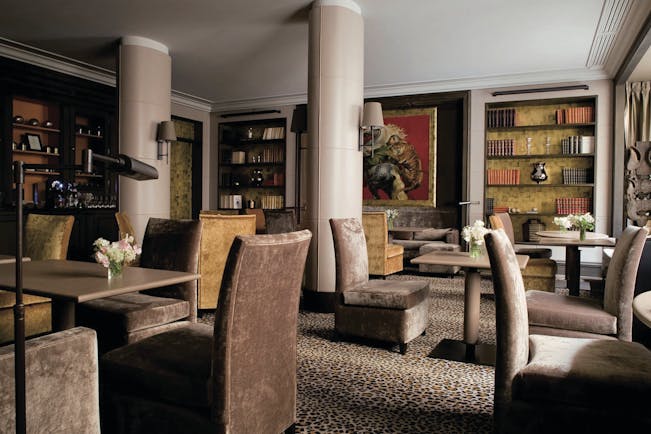 Hotel Esprit Saint Germain Paris library lounge with animal print carpet and large painting of a tiger 