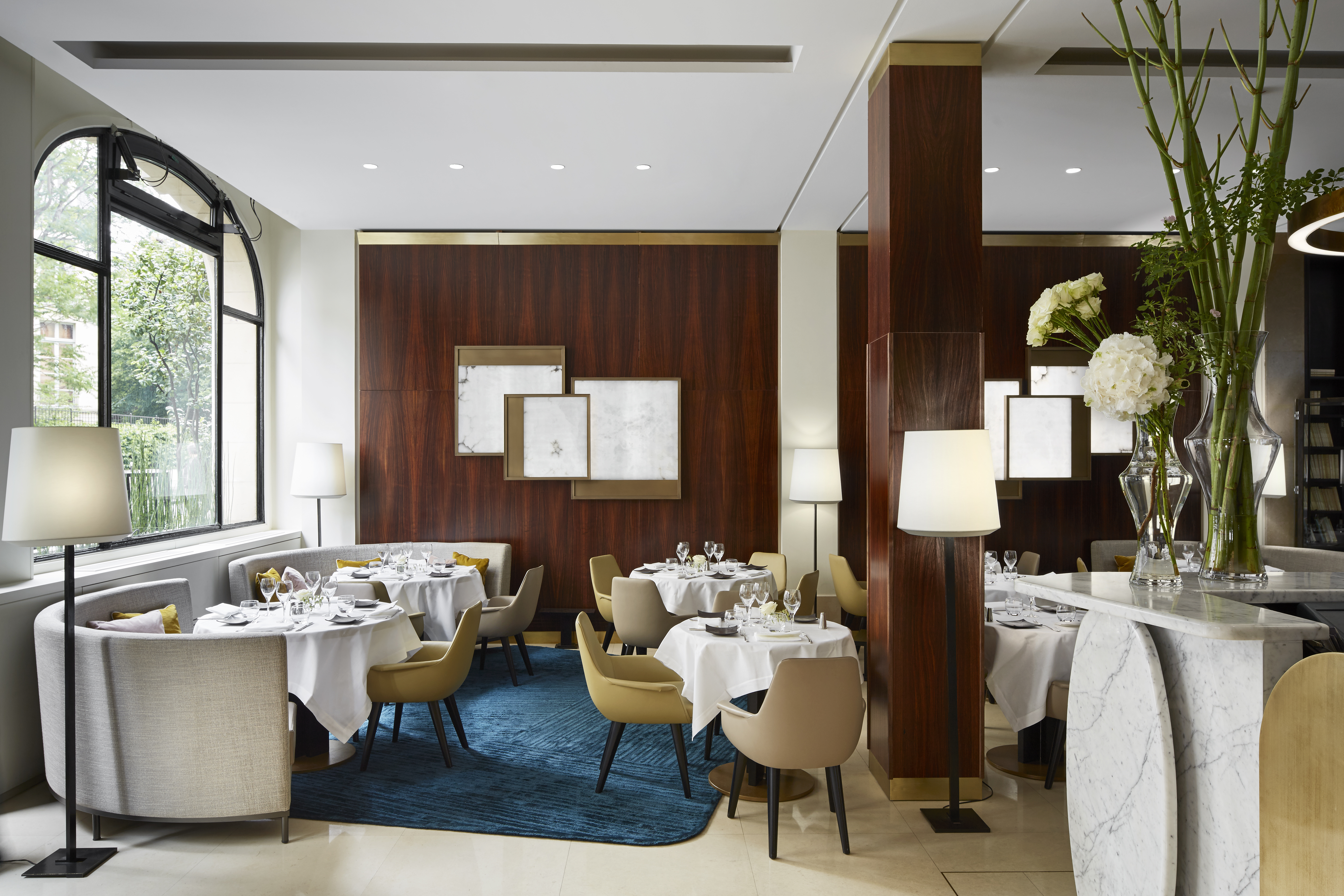 Hotel Montalembert restaurant with white chairs and blue rug