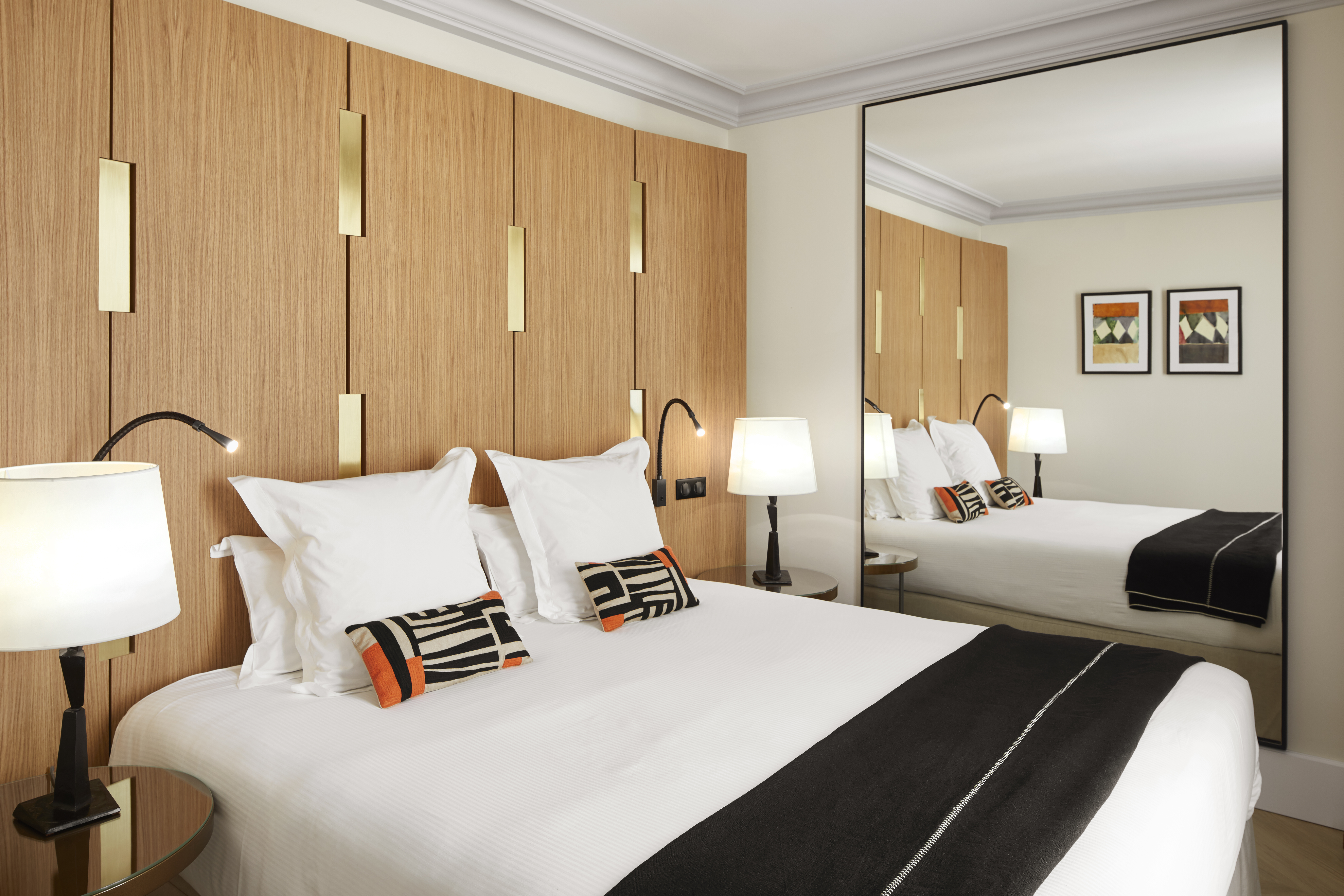 Hotel Montalembert king bed with white cover and large mirror