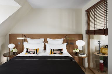 Hotel Montalembert bedroom with shutters and sloping room