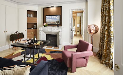 Hotel Montalembert sitting area of suite with fireplace and armchairs