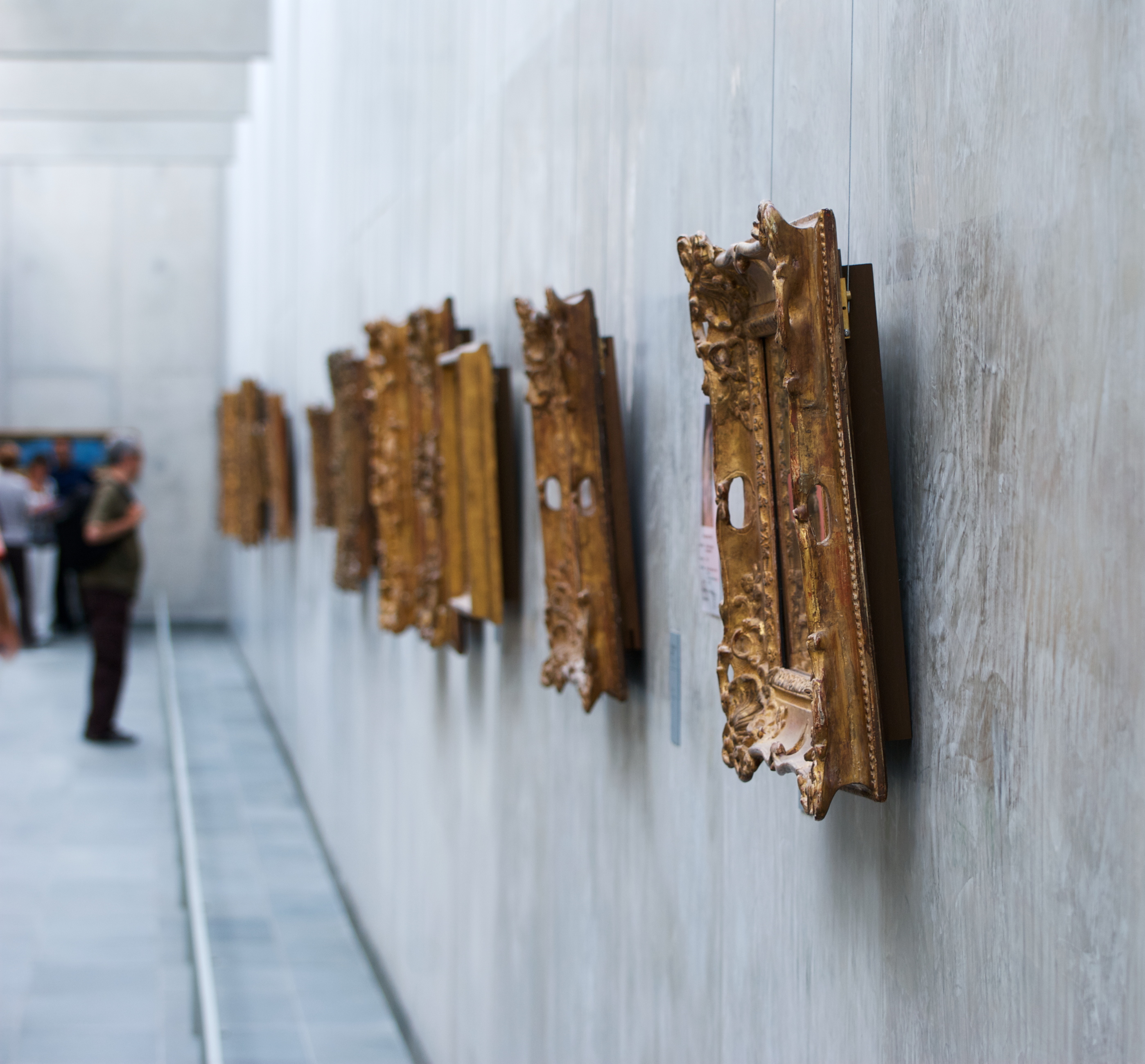 Paintings on a white wall in a Paris art gallery